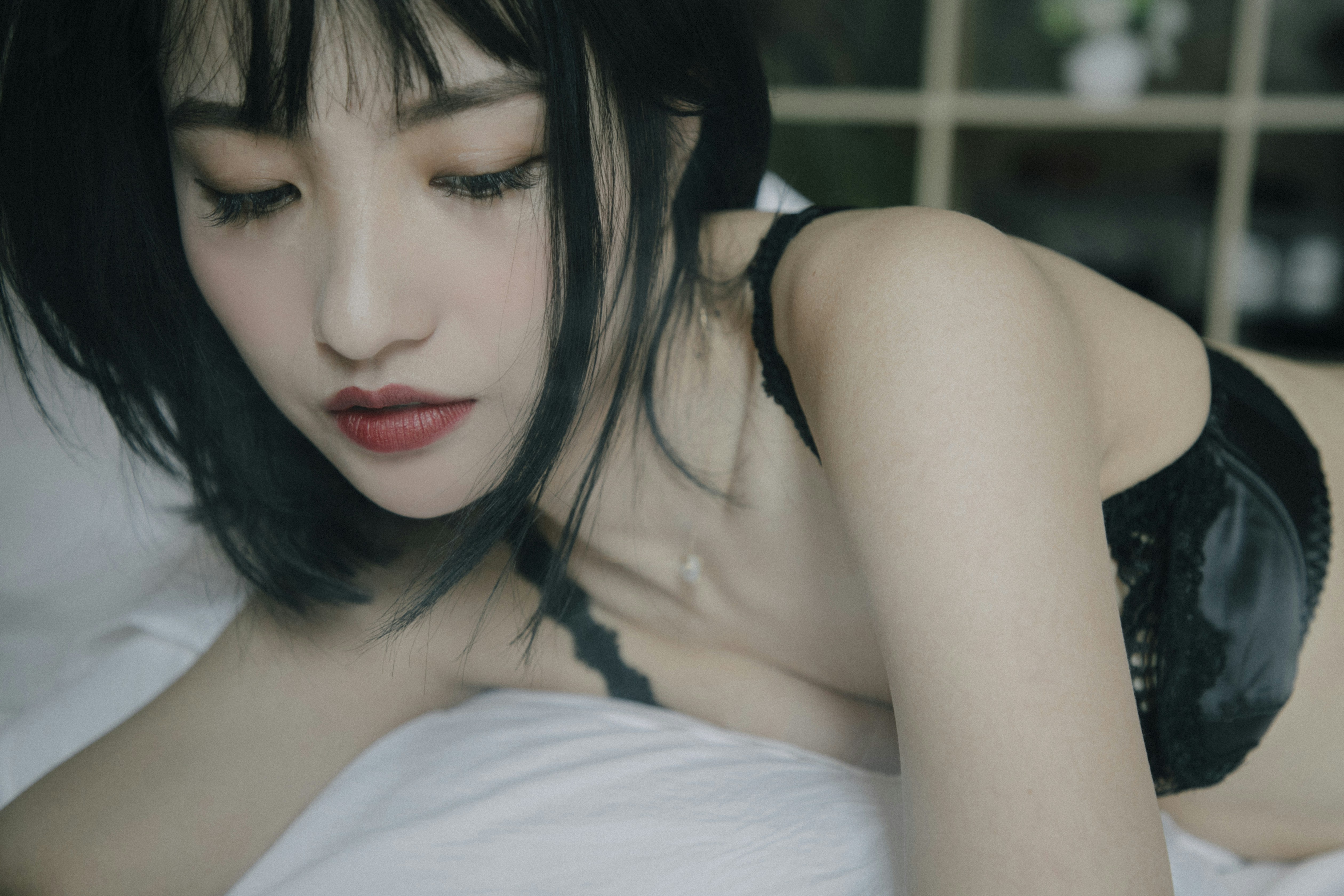 a woman laying in bed with her eyes closed